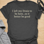 Funny dachshund t-shirt featuring the phrase “I Left My Doxie to Be Here… So It Better Be Good.”
A relatable design for dachshund lovers, sausage dog owners, and pet parents who would always rather be with their dog.
Perfect for doxie moms, doxie dads, and anyone whose little long dog is their favorite companion.
A fun everyday tee and a great gift for devoted dachshund fans with a sense of humor.