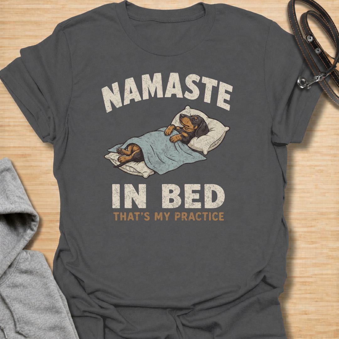 Celebrate the dachshund approach to yoga with this funny “Namaste in Bed” T-shirt. Featuring a cozy sausage dog tucked beneath the blankets with the phrase “That’s My Practice,” it is perfect for dachshund moms, dog dads, homebodies, and yoga lovers. A playful gift for anyone who prefers relaxation, naps, and staying comfortably in bed.