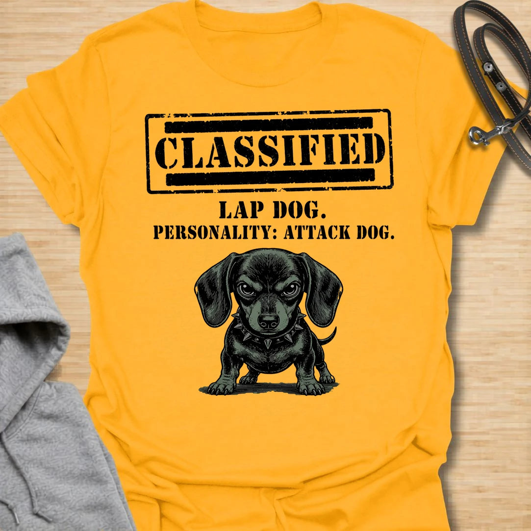 This Classified Lap Dog Personality Attack Dog t-shirt is made for dachshund lovers who know their tiny dog has serious main-character energy. Featuring a classified stamp-style layout, bold text, and a fierce little dachshund illustration, this design has a funny breed-specific attitude that doxie owners will instantly understand. Perfect for dachshund moms, dachshund dads, wiener dog fans, rescue dog lovers, and anyone whose lap dog acts like personal security.