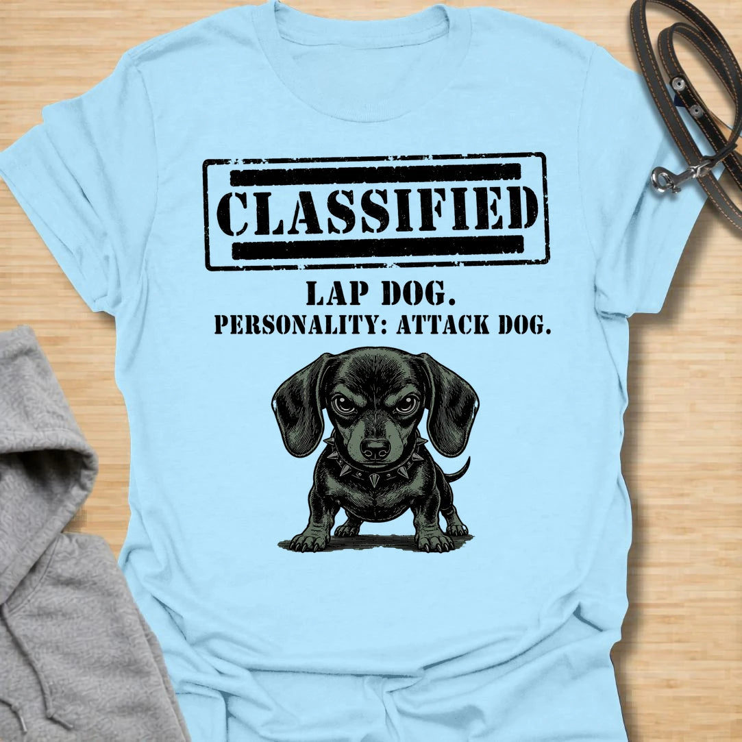This Classified Lap Dog Personality Attack Dog t-shirt is made for dachshund lovers who know their tiny dog has serious main-character energy. Featuring a classified stamp-style layout, bold text, and a fierce little dachshund illustration, this design has a funny breed-specific attitude that doxie owners will instantly understand. Perfect for dachshund moms, dachshund dads, wiener dog fans, rescue dog lovers, and anyone whose lap dog acts like personal security.