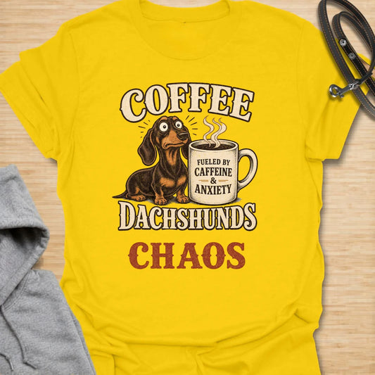 This Coffee Dachshunds Chaos t-shirt is made for doxie lovers who run on caffeine, anxiety, and tiny long-dog drama. Featuring a wide-eyed dachshund beside a coffee mug with bold retro lettering, this funny dog design is great for dachshund moms, dachshund dads, coffee lovers, wiener dog fans, rescue dog lovers, and anyone whose day is fueled by dachshunds and chaos.
