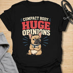 This Compact Body Huge Opinions t-shirt is made for French Bulldog lovers who know their little dog has no shortage of attitude. Featuring a grumpy cartoon Frenchie with folded arms, bold retro lettering, and a funny breed-specific message, this design has a playful dog-parent feel that Frenchie owners will instantly understand. Perfect for Frenchie moms, Frenchie dads, French Bulldog owners, rescue dog lovers, and anyone whose small dog has a very big personality.