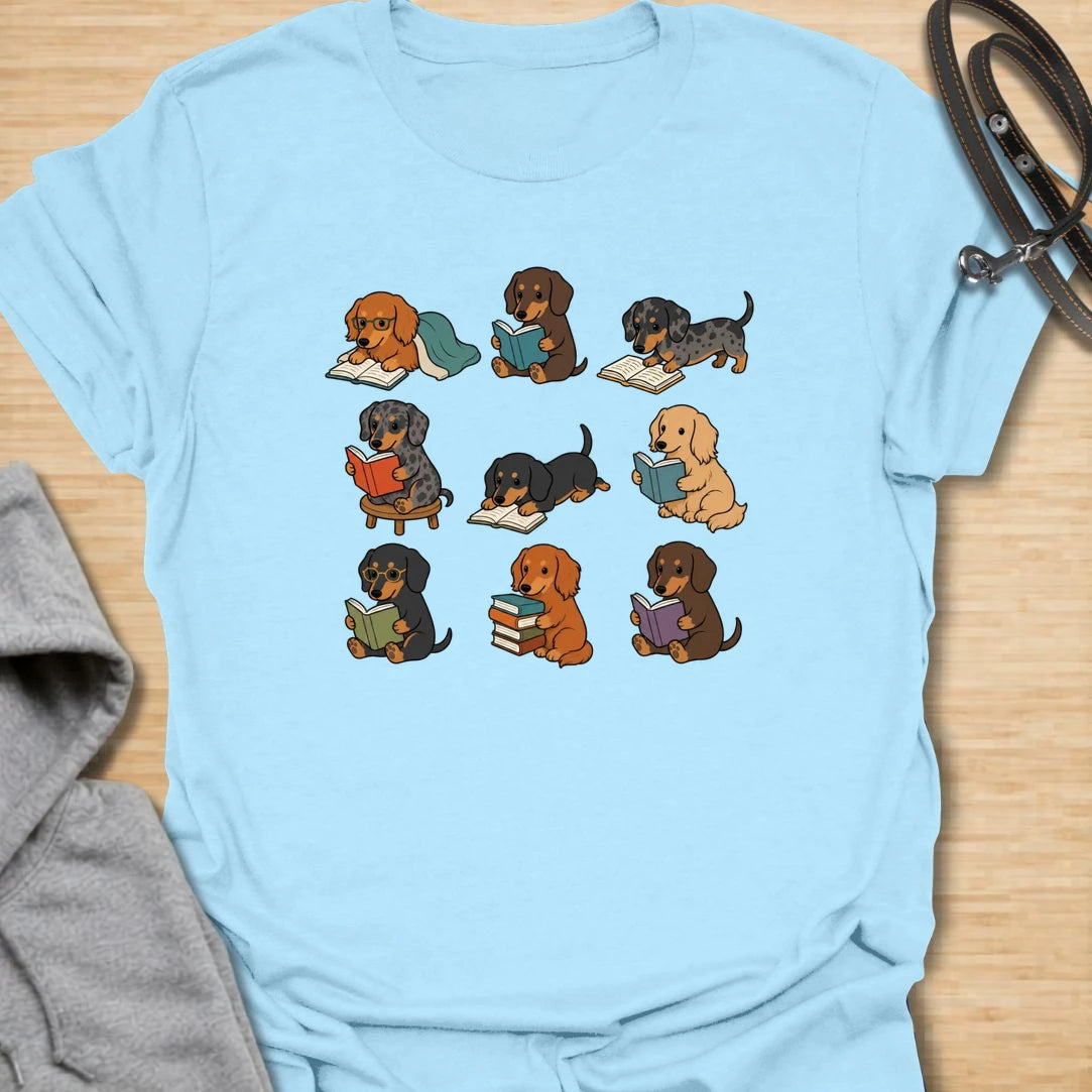 Dachshund Book Club t-shirt for readers who love books almost as much as they love doxies. This sweet design features a group of adorable dachshunds enjoying their books in a cute, cozy book club style. A lovely gift for dachshund moms, dachshund dads, book lovers, teachers, librarians, readers, and anyone who loves sausage dogs. Perfect for casual wear, bookshops, library days, dog walks, reading groups, or cozy weekends.