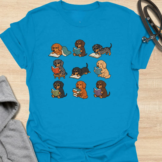 Dachshund Book Club t-shirt for readers who love books almost as much as they love doxies. This sweet design features a group of adorable dachshunds enjoying their books in a cute, cozy book club style. A lovely gift for dachshund moms, dachshund dads, book lovers, teachers, librarians, readers, and anyone who loves sausage dogs. Perfect for casual wear, bookshops, library days, dog walks, reading groups, or cozy weekends.