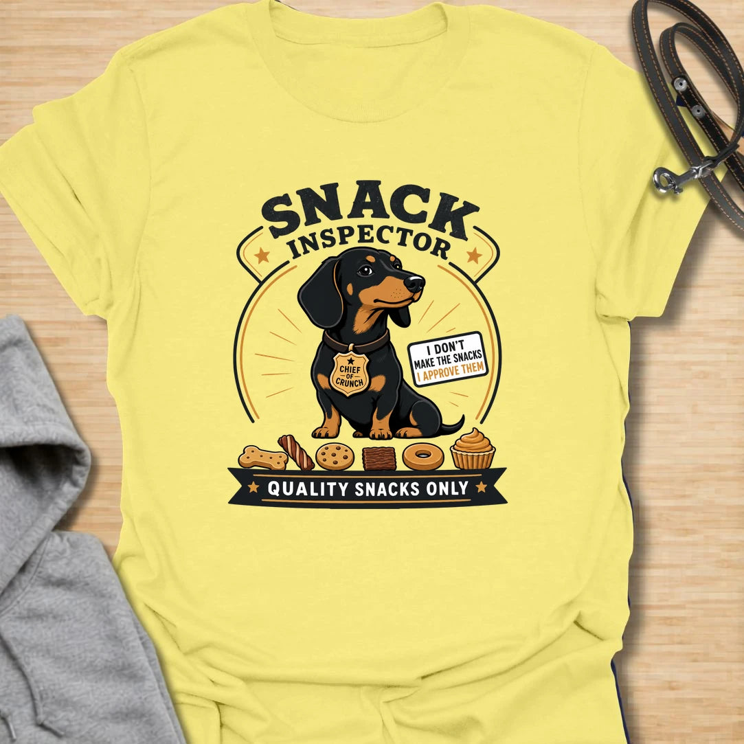 Snack Inspector Dachshund t-shirt for the doxie who takes food quality very seriously. This funny vintage-style design features a dachshund snack inspector with bold badge-style lettering and playful snack details. A perfect gift for dachshund owners whose dog appears the second food is opened. Great for wiener dog lovers, sausage dog fans, and anyone living with a professional crumb detective.