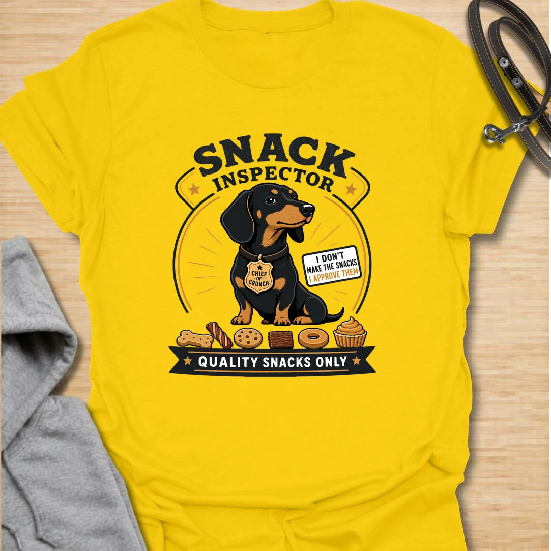 Snack Inspector Dachshund t-shirt for the doxie who takes food quality very seriously. This funny vintage-style design features a dachshund snack inspector with bold badge-style lettering and playful snack details. A perfect gift for dachshund owners whose dog appears the second food is opened. Great for wiener dog lovers, sausage dog fans, and anyone living with a professional crumb detective.
