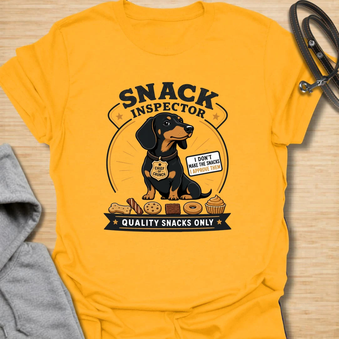 Snack Inspector Dachshund t-shirt for the doxie who takes food quality very seriously. This funny vintage-style design features a dachshund snack inspector with bold badge-style lettering and playful snack details. A perfect gift for dachshund owners whose dog appears the second food is opened. Great for wiener dog lovers, sausage dog fans, and anyone living with a professional crumb detective.