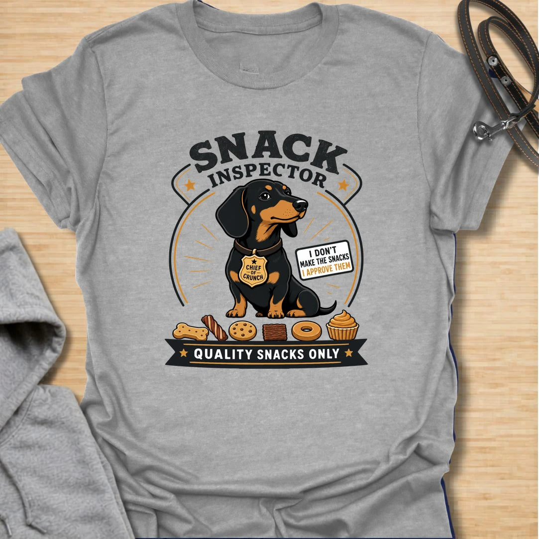 Snack Inspector Dachshund t-shirt for the doxie who takes food quality very seriously. This funny vintage-style design features a dachshund snack inspector with bold badge-style lettering and playful snack details. A perfect gift for dachshund owners whose dog appears the second food is opened. Great for wiener dog lovers, sausage dog fans, and anyone living with a professional crumb detective.