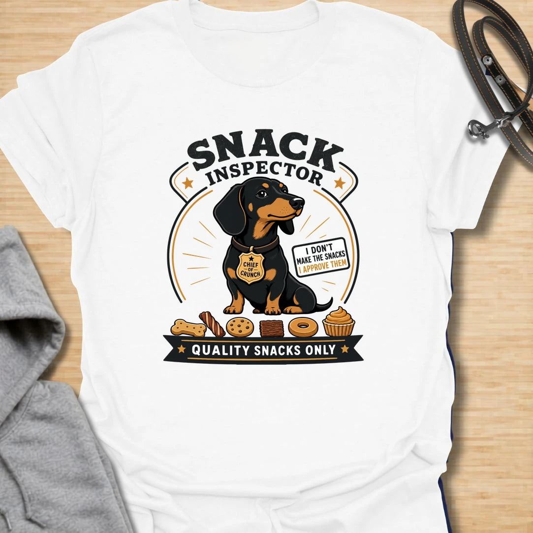 Snack Inspector Dachshund t-shirt for the doxie who takes food quality very seriously. This funny vintage-style design features a dachshund snack inspector with bold badge-style lettering and playful snack details. A perfect gift for dachshund owners whose dog appears the second food is opened. Great for wiener dog lovers, sausage dog fans, and anyone living with a professional crumb detective.