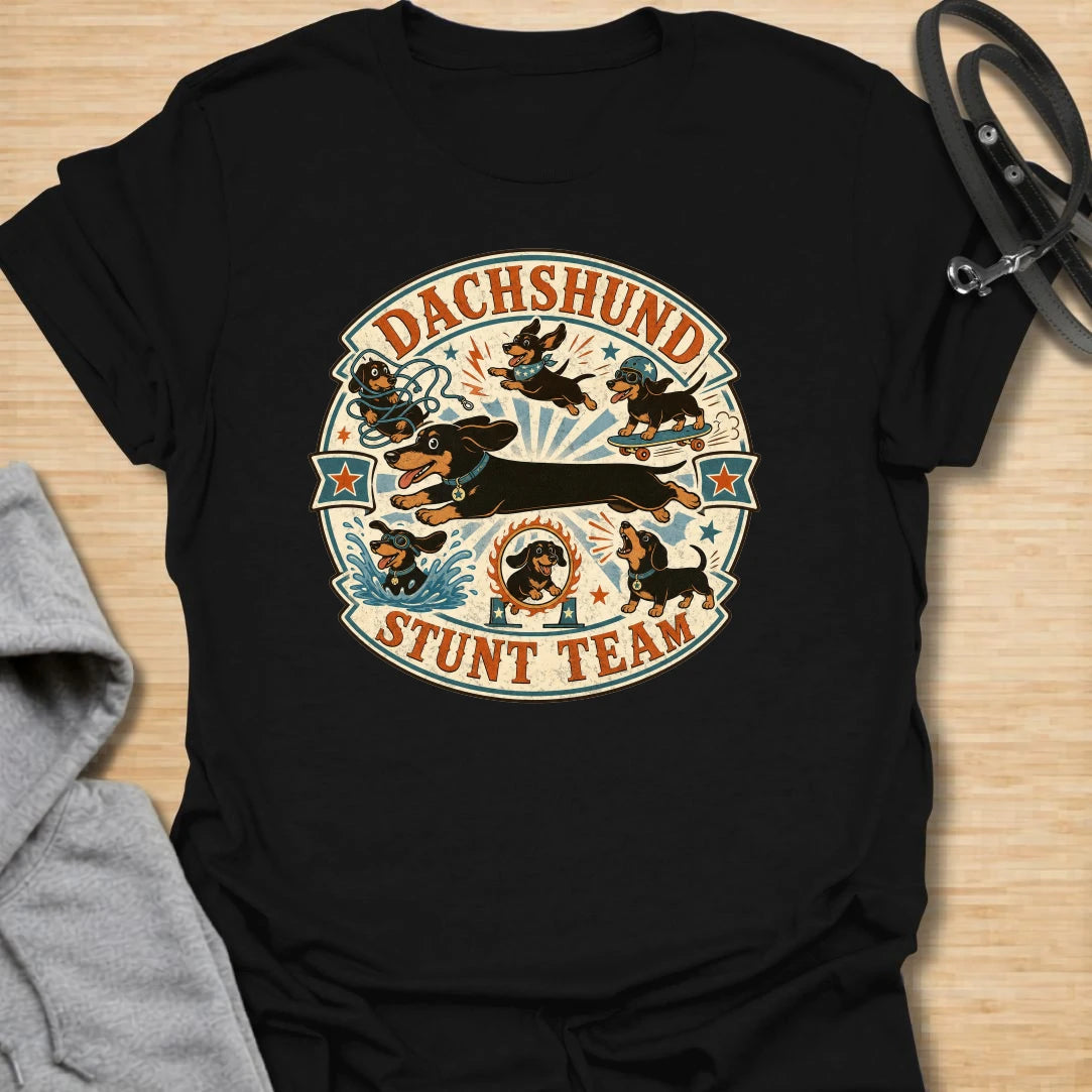 Dachshund Stunt Team t-shirt for sausage dog lovers who know dachshunds treat everyday life like an extreme sport. This vintage circus-style design features adventurous doxies jumping, skating, splashing, barking, and causing chaos. Perfect for dachshund moms, doxie dads, and anyone who loves playful wiener dog humor.