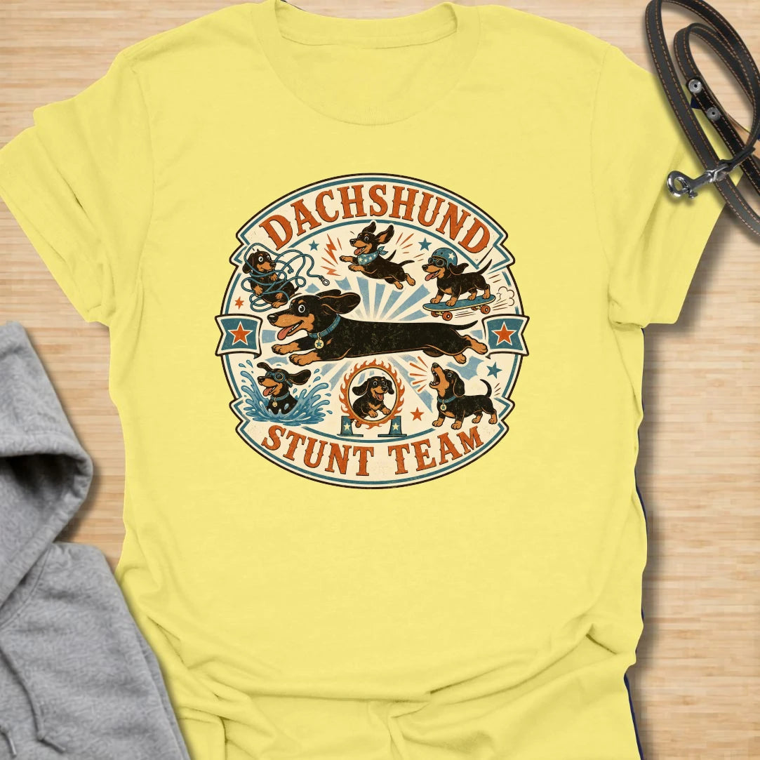 Dachshund Stunt Team t-shirt for sausage dog lovers who know dachshunds treat everyday life like an extreme sport. This vintage circus-style design features adventurous doxies jumping, skating, splashing, barking, and causing chaos. Perfect for dachshund moms, doxie dads, and anyone who loves playful wiener dog humor.
