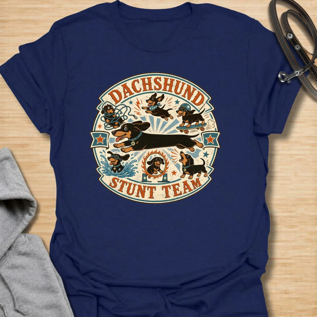 Dachshund Stunt Team t-shirt for sausage dog lovers who know dachshunds treat everyday life like an extreme sport. This vintage circus-style design features adventurous doxies jumping, skating, splashing, barking, and causing chaos. Perfect for dachshund moms, doxie dads, and anyone who loves playful wiener dog humor.