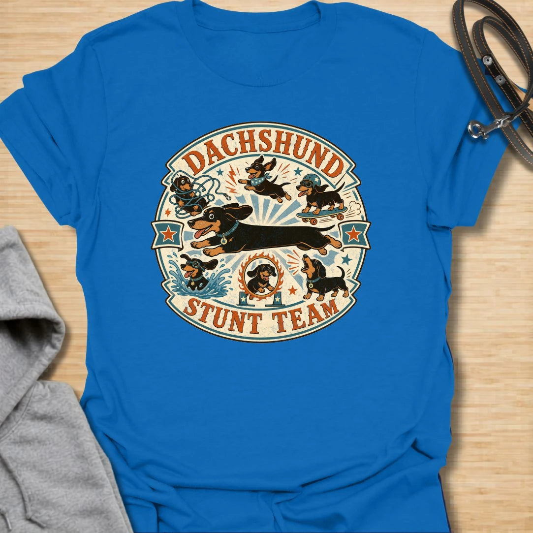 Dachshund Stunt Team t-shirt for sausage dog lovers who know dachshunds treat everyday life like an extreme sport. This vintage circus-style design features adventurous doxies jumping, skating, splashing, barking, and causing chaos. Perfect for dachshund moms, doxie dads, and anyone who loves playful wiener dog humor.