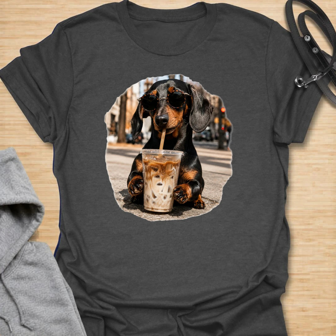This dachshund iced coffee t-shirt is made for dog lovers who run on caffeine and doxie attitude. The cool dachshund in round sunglasses with an iced coffee gives the design a trendy, coffee-shop feel. It is perfect for dachshund moms, coffee lovers, and anyone who thinks their dog has main-character energy. A fun everyday shirt for iced coffee runs, casual weekends, dog walks, or gifting to a dachshund-obsessed friend.