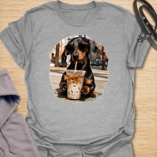 This dachshund iced coffee t-shirt is made for dog lovers who run on caffeine and doxie attitude. The cool dachshund in round sunglasses with an iced coffee gives the design a trendy, coffee-shop feel. It is perfect for dachshund moms, coffee lovers, and anyone who thinks their dog has main-character energy. A fun everyday shirt for iced coffee runs, casual weekends, dog walks, or gifting to a dachshund-obsessed friend.
