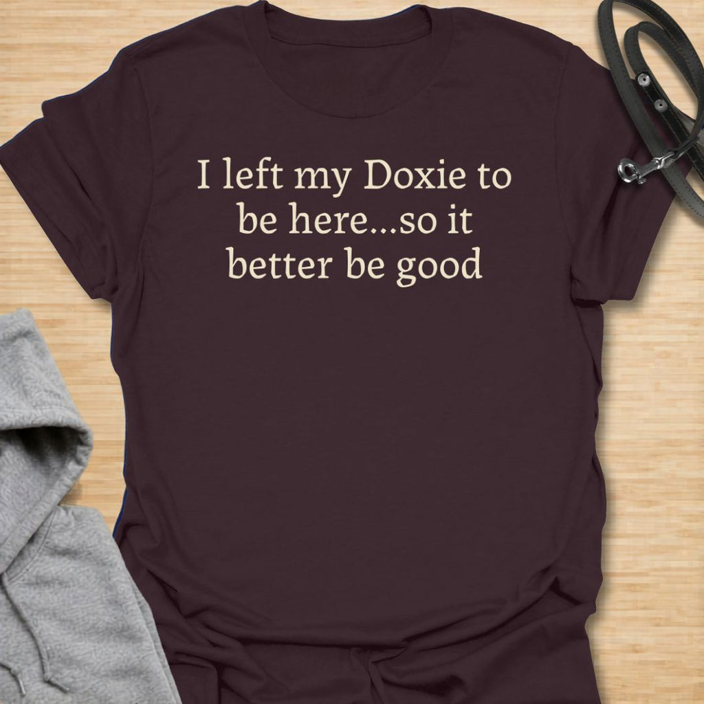 Funny dachshund t-shirt featuring the phrase “I Left My Doxie to Be Here… So It Better Be Good.”
A relatable design for dachshund lovers, sausage dog owners, and pet parents who would always rather be with their dog.
Perfect for doxie moms, doxie dads, and anyone whose little long dog is their favorite companion.
A fun everyday tee and a great gift for devoted dachshund fans with a sense of humor.