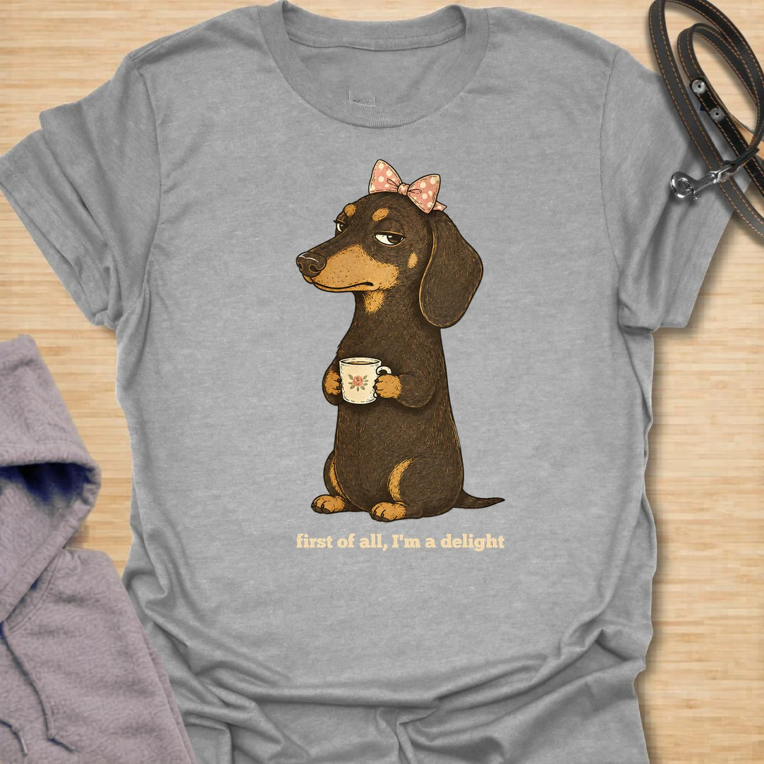 This First Of All I’m A Delight t-shirt is made for dachshund lovers who know their little long dog may be dramatic, judgmental, and demanding, but still completely adorable. Featuring a cute dachshund with a bow and mug, this design has a funny sweet-but-sassy dog-parent feel. Perfect for dachshund moms, doxie lovers, wiener dog fans, rescue dog lovers, and anyone whose dachshund is convinced they are a delight.