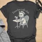 This Frenchie Café Club t-shirt is made for French Bulldog lovers who enjoy a little café charm with their dog-parent style. Featuring a vintage-style Frenchie sitting at a bistro table with a drink and beret, this design has a refined, playful feel with classic French café personality. Perfect for Frenchie moms, Frenchie dads, French Bulldog owners, coffee lovers, café fans, and anyone who loves their small dog with a side of attitude.