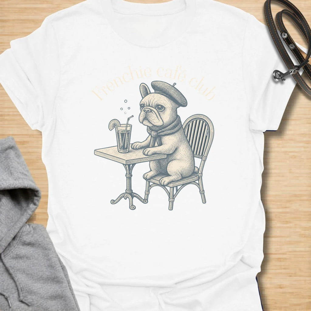 This Frenchie Café Club t-shirt is made for French Bulldog lovers who enjoy a little café charm with their dog-parent style. Featuring a vintage-style Frenchie sitting at a bistro table with a drink and beret, this design has a refined, playful feel with classic French café personality. Perfect for Frenchie moms, Frenchie dads, French Bulldog owners, coffee lovers, café fans, and anyone who loves their small dog with a side of attitude.
