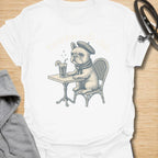 This Frenchie Café Club t-shirt is made for French Bulldog lovers who enjoy a little café charm with their dog-parent style. Featuring a vintage-style Frenchie sitting at a bistro table with a drink and beret, this design has a refined, playful feel with classic French café personality. Perfect for Frenchie moms, Frenchie dads, French Bulldog owners, coffee lovers, café fans, and anyone who loves their small dog with a side of attitude.