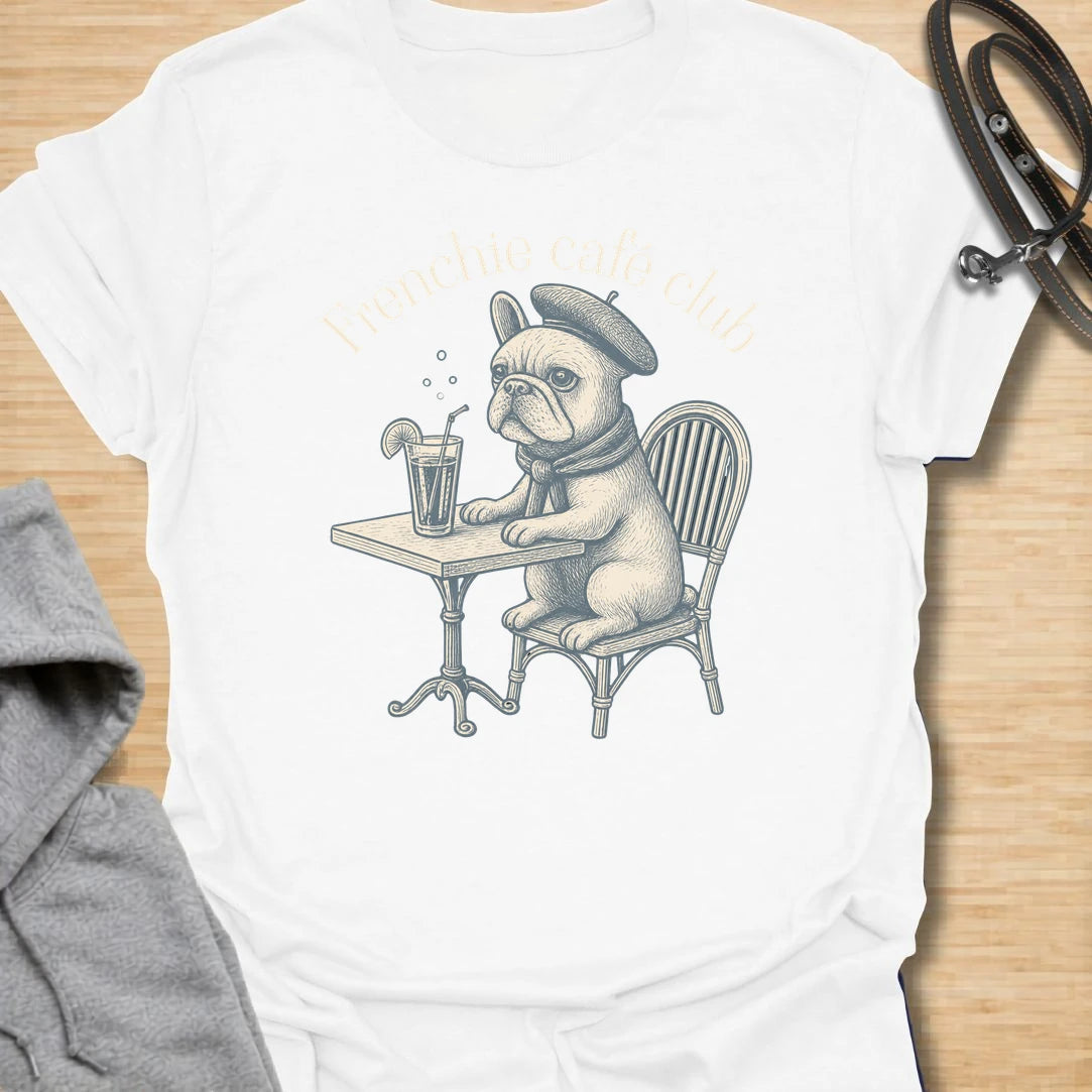 This Frenchie Café Club t-shirt is made for French Bulldog lovers who enjoy a little café charm with their dog-parent style. Featuring a vintage-style Frenchie sitting at a bistro table with a drink and beret, this design has a refined, playful feel with classic French café personality. Perfect for Frenchie moms, Frenchie dads, French Bulldog owners, coffee lovers, café fans, and anyone who loves their small dog with a side of attitude.