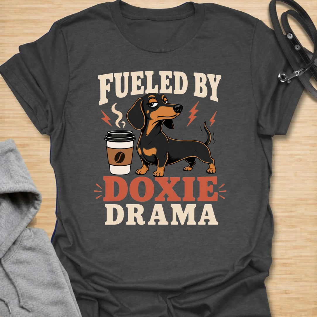 This Fueled By Doxie Drama t-shirt is made for dachshund lovers who know their little long dog brings attitude, opinions, and daily entertainment. Featuring a sassy black and tan dachshund with a coffee cup, bold retro lettering, and playful lightning details, this funny dog design is great for dachshund moms, dachshund dads, coffee lovers, wiener dog fans, and anyone powered by caffeine and doxie chaos.