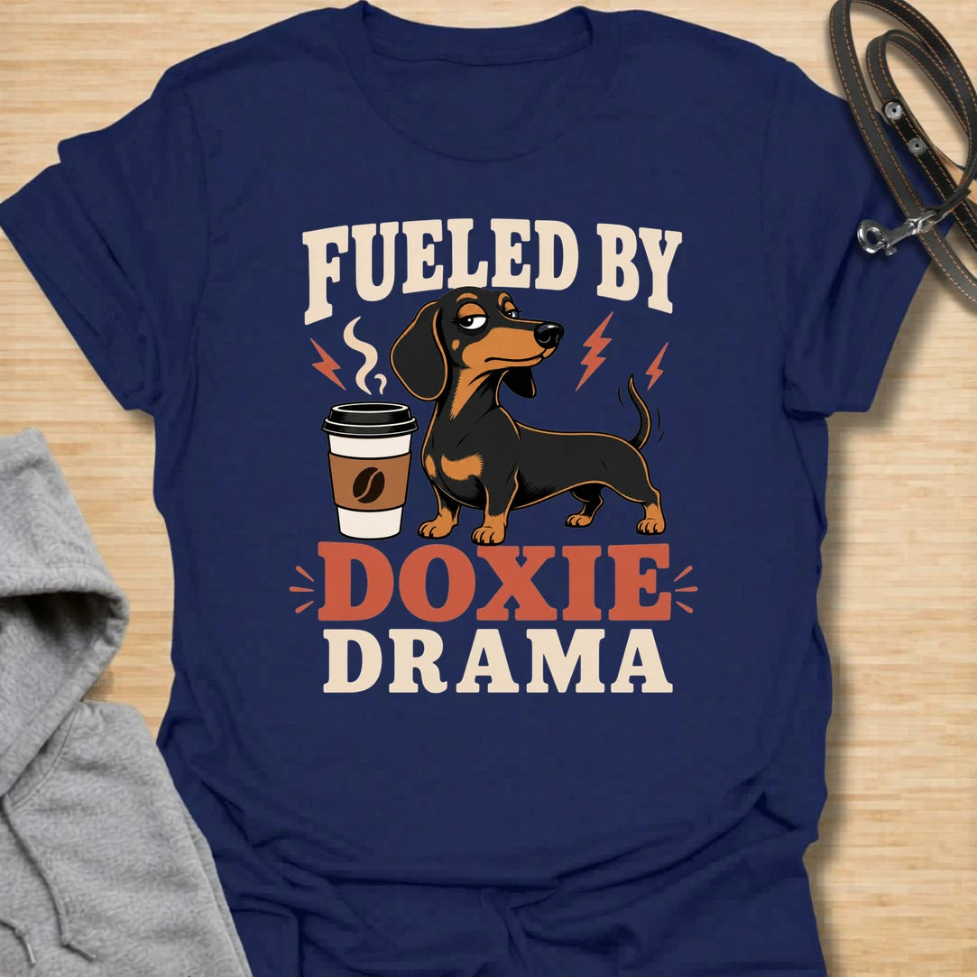 This Fueled By Doxie Drama t-shirt is made for dachshund lovers who know their little long dog brings attitude, opinions, and daily entertainment. Featuring a sassy black and tan dachshund with a coffee cup, bold retro lettering, and playful lightning details, this funny dog design is great for dachshund moms, dachshund dads, coffee lovers, wiener dog fans, and anyone powered by caffeine and doxie chaos.
