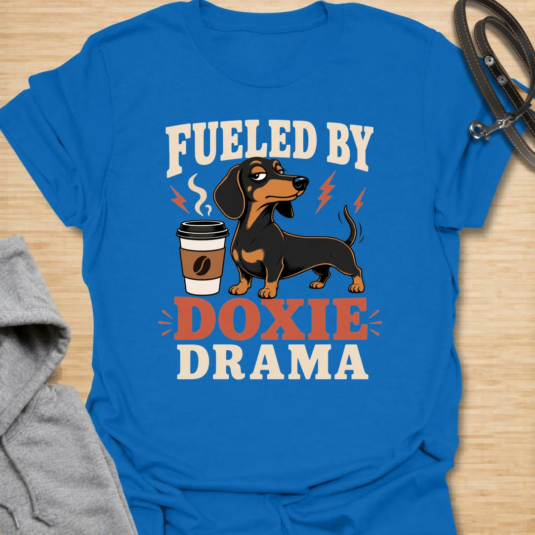 This Fueled By Doxie Drama t-shirt is made for dachshund lovers who know their little long dog brings attitude, opinions, and daily entertainment. Featuring a sassy black and tan dachshund with a coffee cup, bold retro lettering, and playful lightning details, this funny dog design is great for dachshund moms, dachshund dads, coffee lovers, wiener dog fans, and anyone powered by caffeine and doxie chaos.