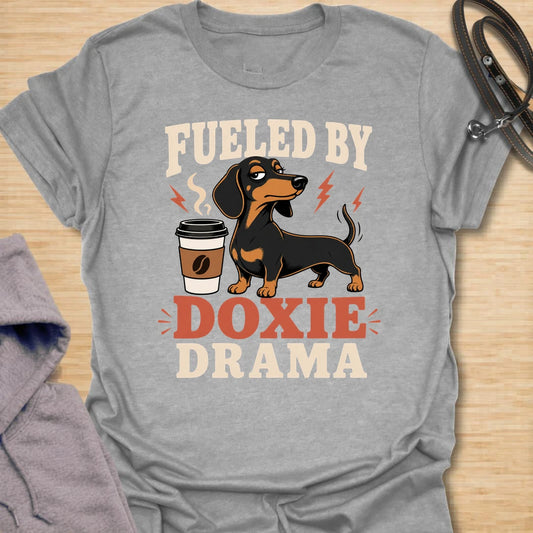 This Fueled By Doxie Drama t-shirt is made for dachshund lovers who know their little long dog brings attitude, opinions, and daily entertainment. Featuring a sassy black and tan dachshund with a coffee cup, bold retro lettering, and playful lightning details, this funny dog design is great for dachshund moms, dachshund dads, coffee lovers, wiener dog fans, and anyone powered by caffeine and doxie chaos.

