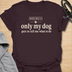This Only My Dog Gets To Tell Me What To Do t-shirt is made for dog owners who know exactly who is really in charge at home. Featuring a simple text-only layout with a small paw print and the phrase House Rule #1, this design has a funny, relatable dog-parent feel that is easy to wear every day. Perfect for dog moms, dog dads, rescue dog owners, pet parents, and anyone who happily takes orders from their four-legged boss. Dark Chocolate