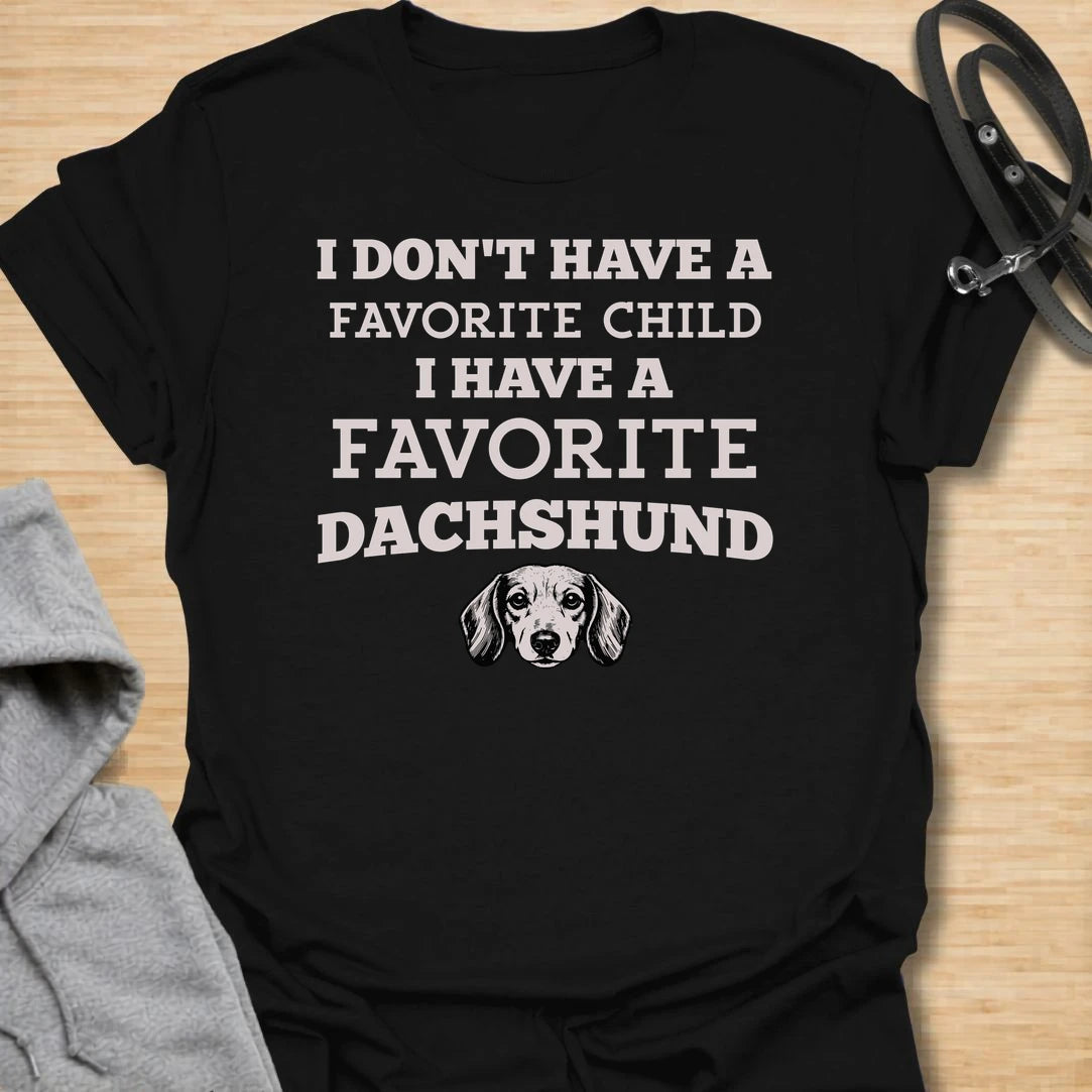 This I Have A Favorite Dachshund t-shirt is made for doxie lovers who know exactly where their loyalty lies. Featuring bold vintage-style typography, a small dachshund face illustration, and the funny phrase I Don’t Have A Favorite Child I Have A Favorite Dachshund, this design has a playful dog-parent feel that wiener dog fans will instantly understand. Perfect for dachshund moms, dachshund dads, doxie owners, rescue dog lovers, and anyone whose favorite family member has tiny legs and a long body.