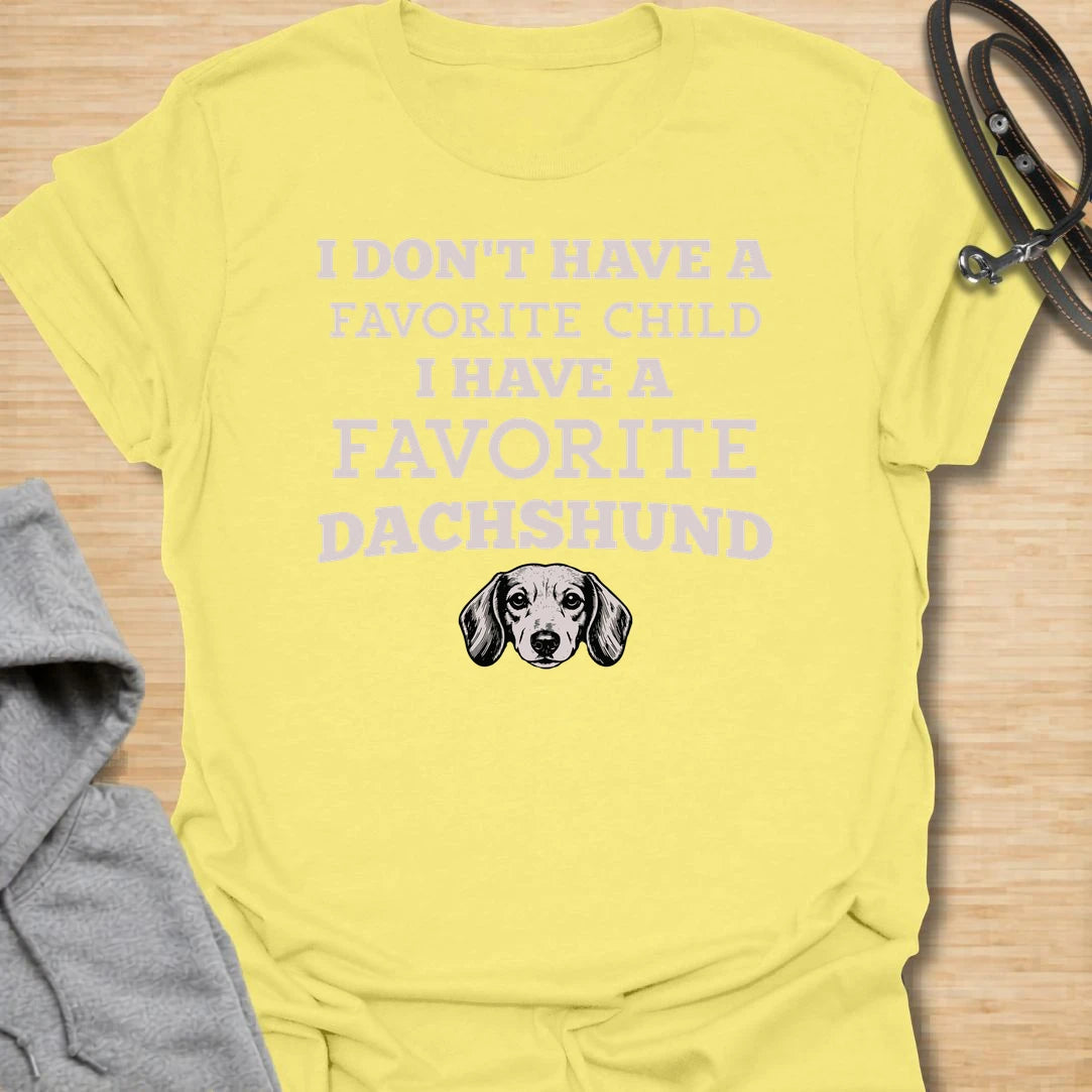 This I Have A Favorite Dachshund t-shirt is made for doxie lovers who know exactly where their loyalty lies. Featuring bold vintage-style typography, a small dachshund face illustration, and the funny phrase I Don’t Have A Favorite Child I Have A Favorite Dachshund, this design has a playful dog-parent feel that wiener dog fans will instantly understand. Perfect for dachshund moms, dachshund dads, doxie owners, rescue dog lovers, and anyone whose favorite family member has tiny legs and a long body.