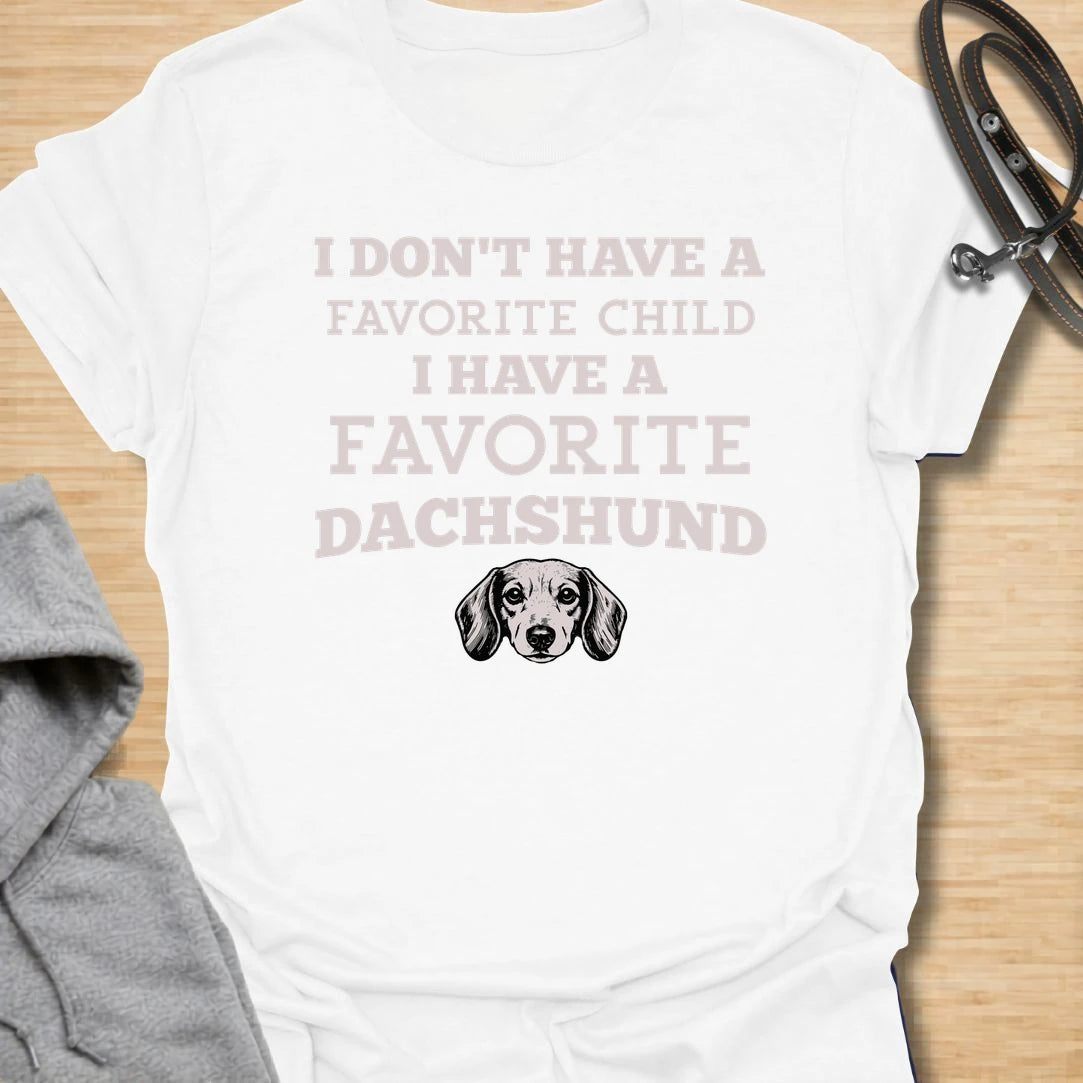 This I Have A Favorite Dachshund t-shirt is made for doxie lovers who know exactly where their loyalty lies. Featuring bold vintage-style typography, a small dachshund face illustration, and the funny phrase I Don’t Have A Favorite Child I Have A Favorite Dachshund, this design has a playful dog-parent feel that wiener dog fans will instantly understand. Perfect for dachshund moms, dachshund dads, doxie owners, rescue dog lovers, and anyone whose favorite family member has tiny legs and a long body.