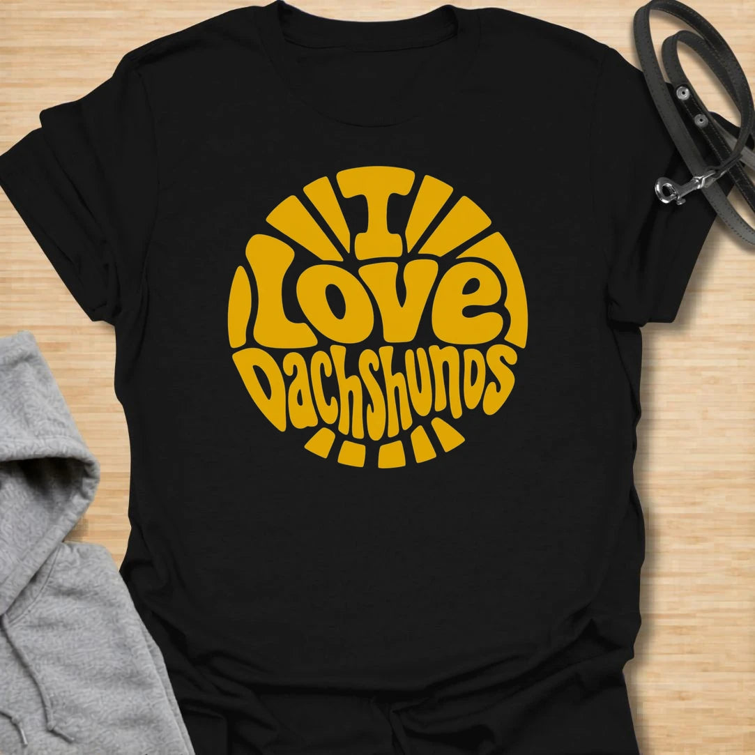 I Love Dachshunds t-shirt for dachshund lovers, dog moms, and doxie fans who can never get enough of their favorite long little dogs. The bold retro-style lettering and sunshine layout give this design a fun, cheerful look that stands out. It is perfect for dachshund moms, dachshund dads, wiener dog owners, and anyone proud to show off their love for the breed. A great everyday shirt or gift for dog lovers who believe life is simply better with dachshunds.