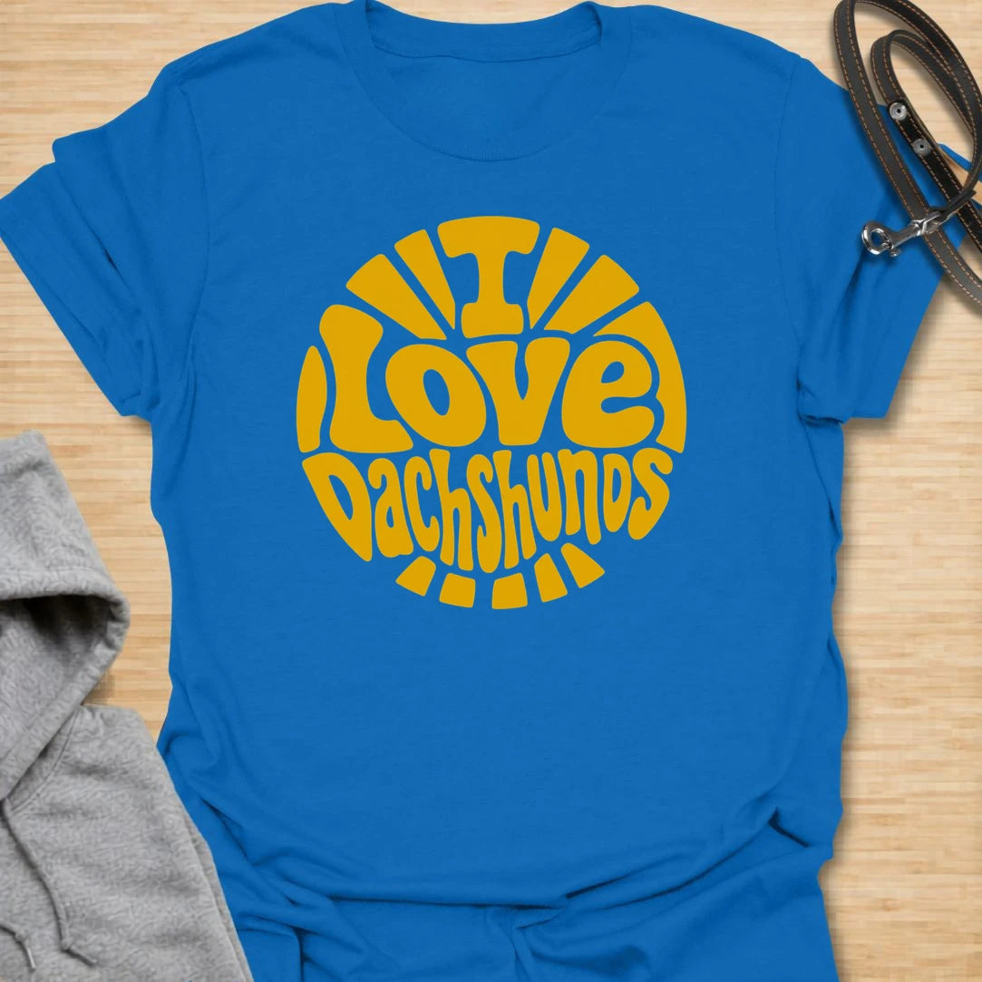 I Love Dachshunds t-shirt for dachshund lovers, dog moms, and doxie fans who can never get enough of their favorite long little dogs. The bold retro-style lettering and sunshine layout give this design a fun, cheerful look that stands out. It is perfect for dachshund moms, dachshund dads, wiener dog owners, and anyone proud to show off their love for the breed. A great everyday shirt or gift for dog lovers who believe life is simply better with dachshunds.