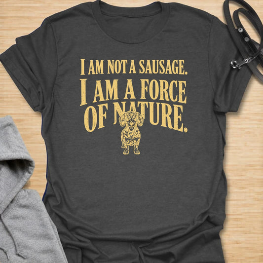 This I Am Not A Sausage I Am A Force Of Nature t-shirt is made for dachshund lovers who know their little long dog is far more powerful than their tiny legs suggest. Featuring bold vintage-style typography and a small fierce dachshund illustration, this design has a funny breed-specific attitude that doxie owners will instantly understand. Perfect for dachshund moms, dachshund dads, wiener dog fans, rescue dog lovers, and anyone whose sausage dog is an unstoppable force of nature.