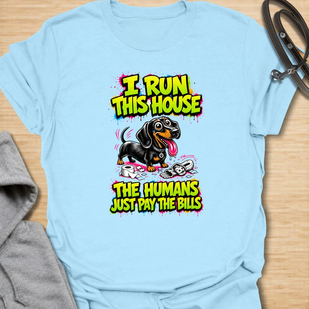 Run This House t-shirt for dachshund lovers who know the smallest dog in the home is usually the one in charge. This bold comic-style design features a mischievous doxie and the phrase “I Run This House The Humans Just Pay The Bills.” Perfect for sausage dog owners, doxie moms, and anyone whose dog rules the household.