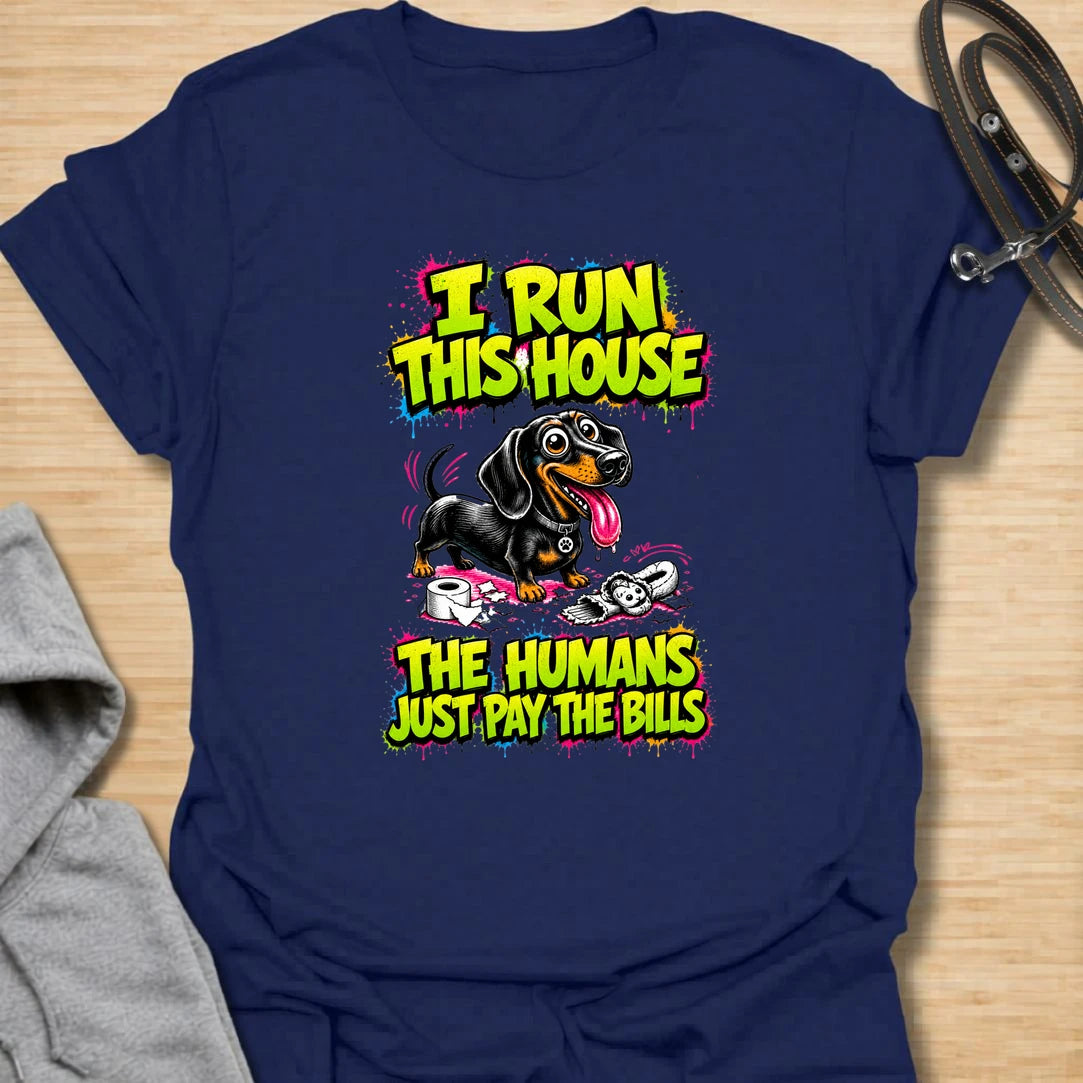 Run This House t-shirt for dachshund lovers who know the smallest dog in the home is usually the one in charge. This bold comic-style design features a mischievous doxie and the phrase “I Run This House The Humans Just Pay The Bills.” Perfect for sausage dog owners, doxie moms, and anyone whose dog rules the household.