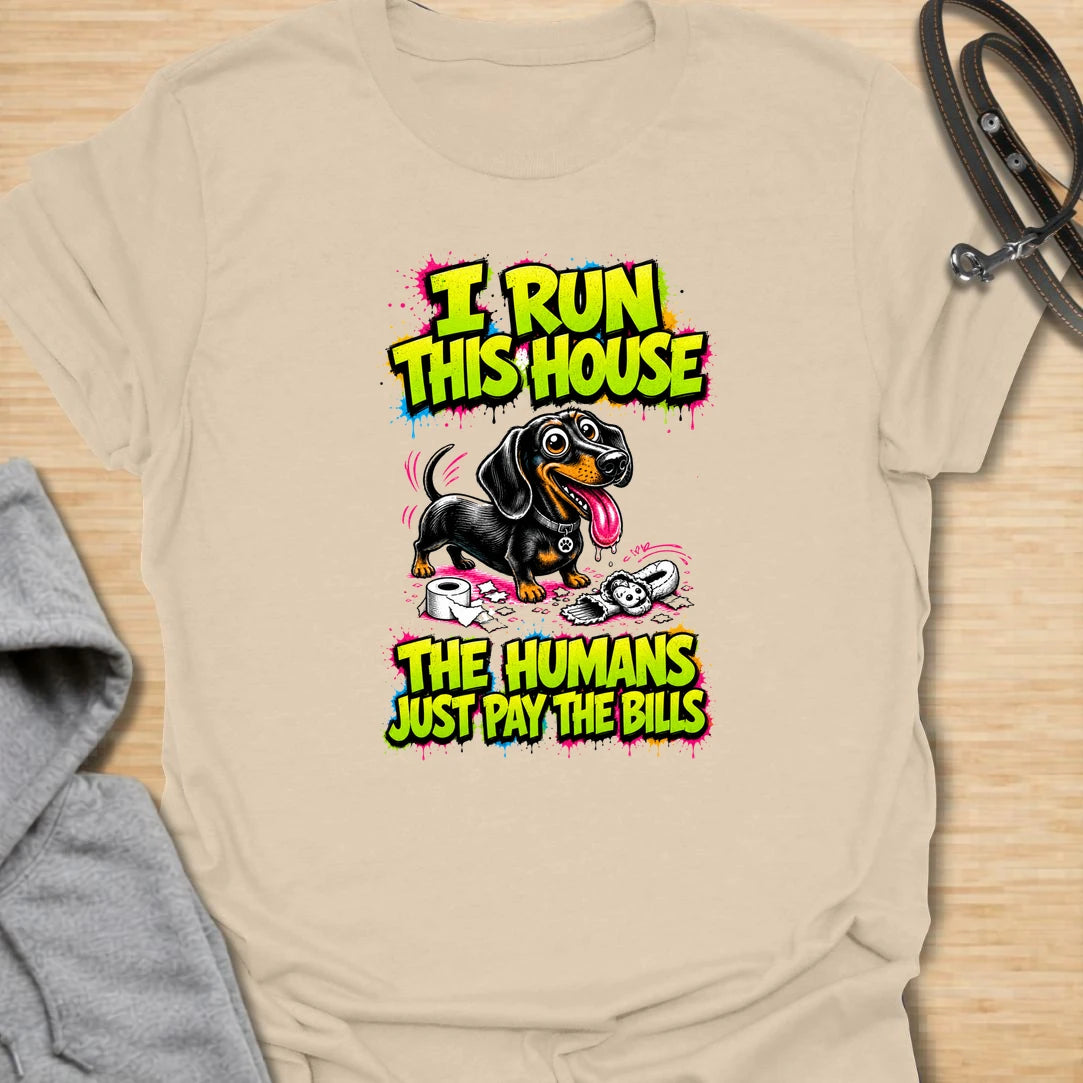 Run This House t-shirt for dachshund lovers who know the smallest dog in the home is usually the one in charge. This bold comic-style design features a mischievous doxie and the phrase “I Run This House The Humans Just Pay The Bills.” Perfect for sausage dog owners, doxie moms, and anyone whose dog rules the household.
