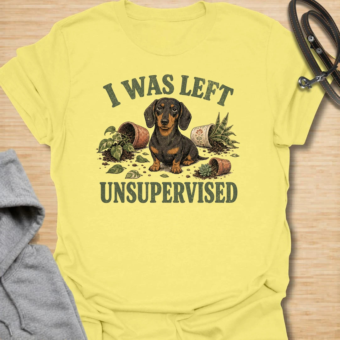 This I Was Left Unsupervised t-shirt is made for dachshund lovers who know their little long dog can create a whole disaster in record time. Featuring a guilty-looking dachshund surrounded by knocked-over plant pots and soil, this design has a funny chaotic dog-parent feel. Perfect for dachshund moms, dachshund dads, wiener dog fans, rescue dog lovers, plant lovers, and anyone whose doxie cannot be trusted alone.