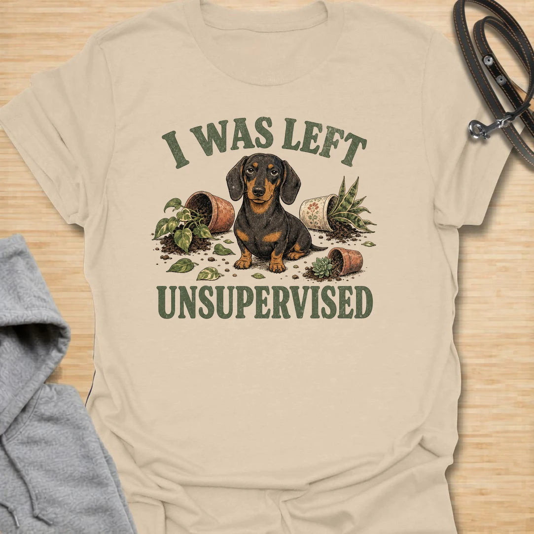 This I Was Left Unsupervised t-shirt is made for dachshund lovers who know their little long dog can create a whole disaster in record time. Featuring a guilty-looking dachshund surrounded by knocked-over plant pots and soil, this design has a funny chaotic dog-parent feel. Perfect for dachshund moms, dachshund dads, wiener dog fans, rescue dog lovers, plant lovers, and anyone whose doxie cannot be trusted alone.