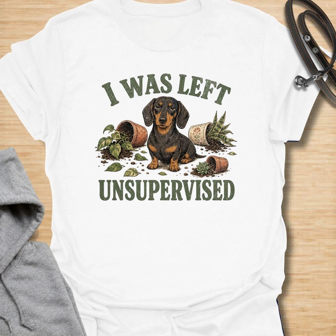 This I Was Left Unsupervised t-shirt is made for dachshund lovers who know their little long dog can create a whole disaster in record time. Featuring a guilty-looking dachshund surrounded by knocked-over plant pots and soil, this design has a funny chaotic dog-parent feel. Perfect for dachshund moms, dachshund dads, wiener dog fans, rescue dog lovers, plant lovers, and anyone whose doxie cannot be trusted alone.