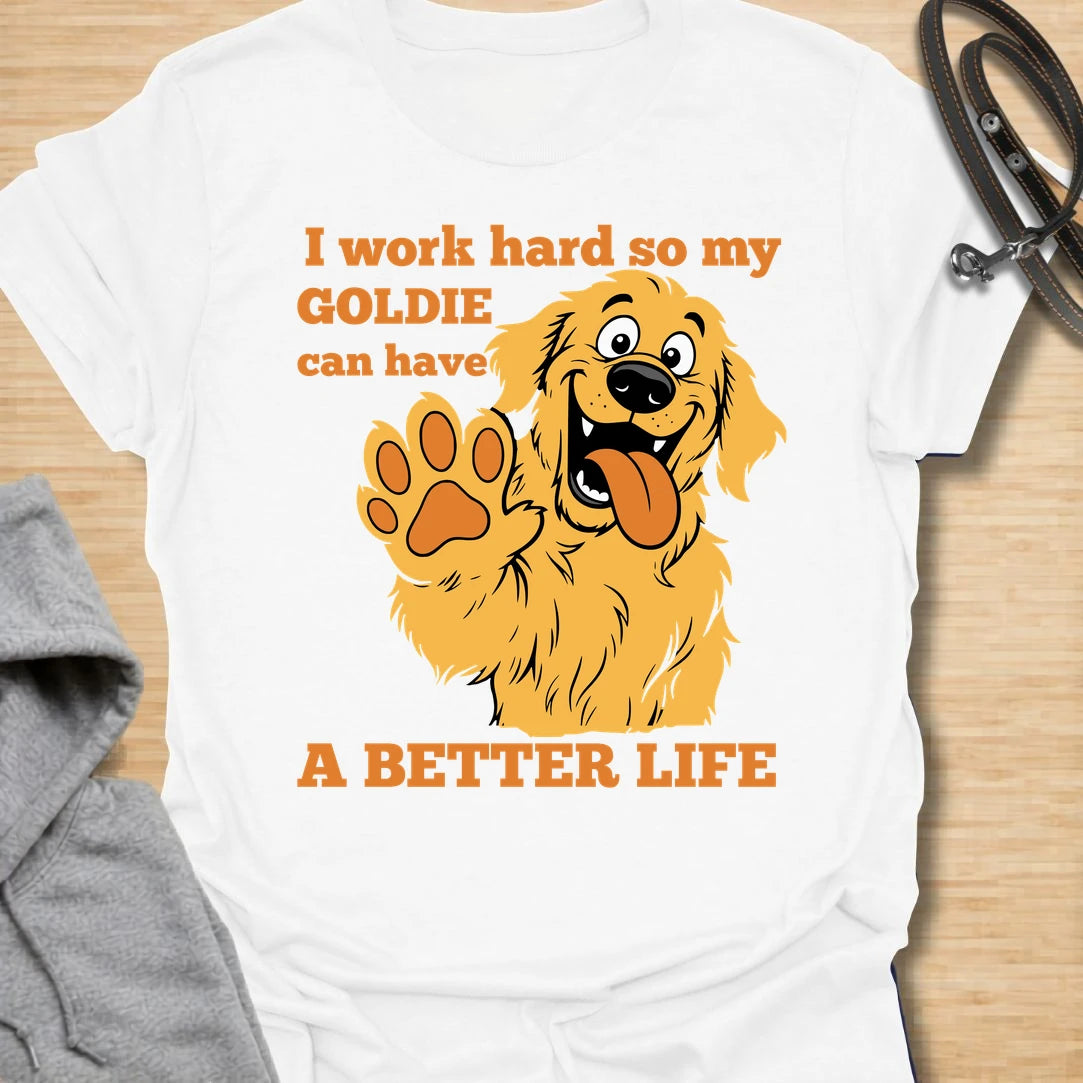 This I Work Hard So My Goldie Can Have A Better Life t-shirt is made for Golden Retriever owners who know exactly where their money, time, and attention really go. Featuring a happy cartoon Goldie with a big smile, raised paw, and playful bold lettering, this design has a funny, lovable dog-parent feel. Perfect for Golden Retriever moms, Golden Retriever dads, Goldie lovers, rescue dog owners, and anyone who proudly spoils their golden best friend. White