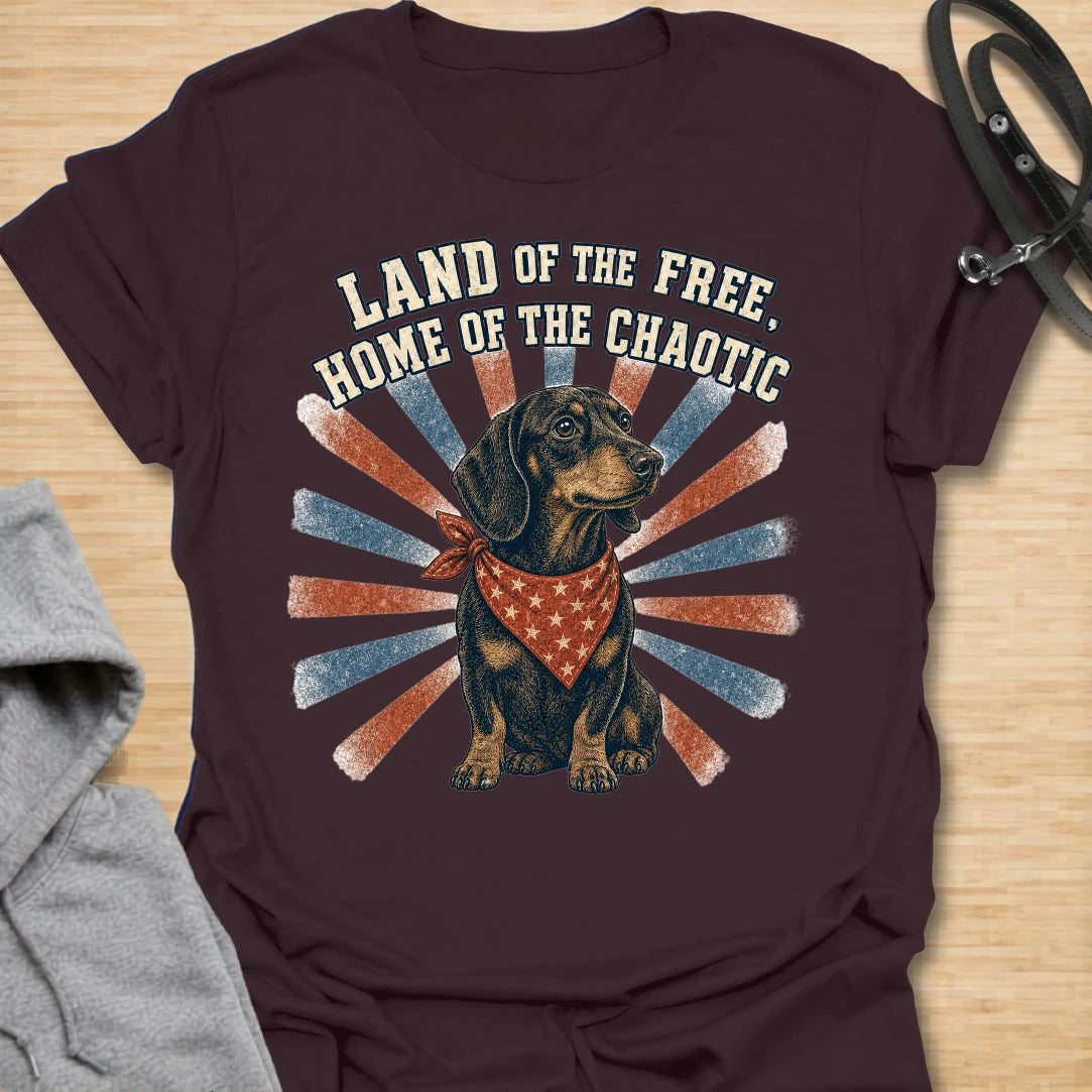 This Land Of The Free Home Of The Chaotic t-shirt is made for dachshund lovers who know their little long dog brings big energy everywhere they go. Featuring a black and tan doxie with a red bandana, vintage patriotic-style rays, and bold distressed text, this funny dog design is great for dachshund moms, dachshund dads, wiener dog fans, rescue dog lovers, and anyone whose home is proudly ruled by dachshund chaos.