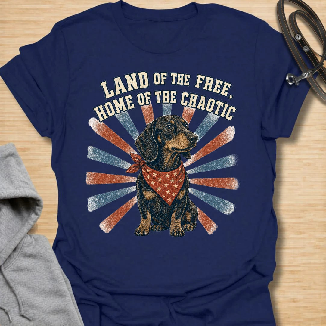 This Land Of The Free Home Of The Chaotic t-shirt is made for dachshund lovers who know their little long dog brings big energy everywhere they go. Featuring a black and tan doxie with a red bandana, vintage patriotic-style rays, and bold distressed text, this funny dog design is great for dachshund moms, dachshund dads, wiener dog fans, rescue dog lovers, and anyone whose home is proudly ruled by dachshund chaos.