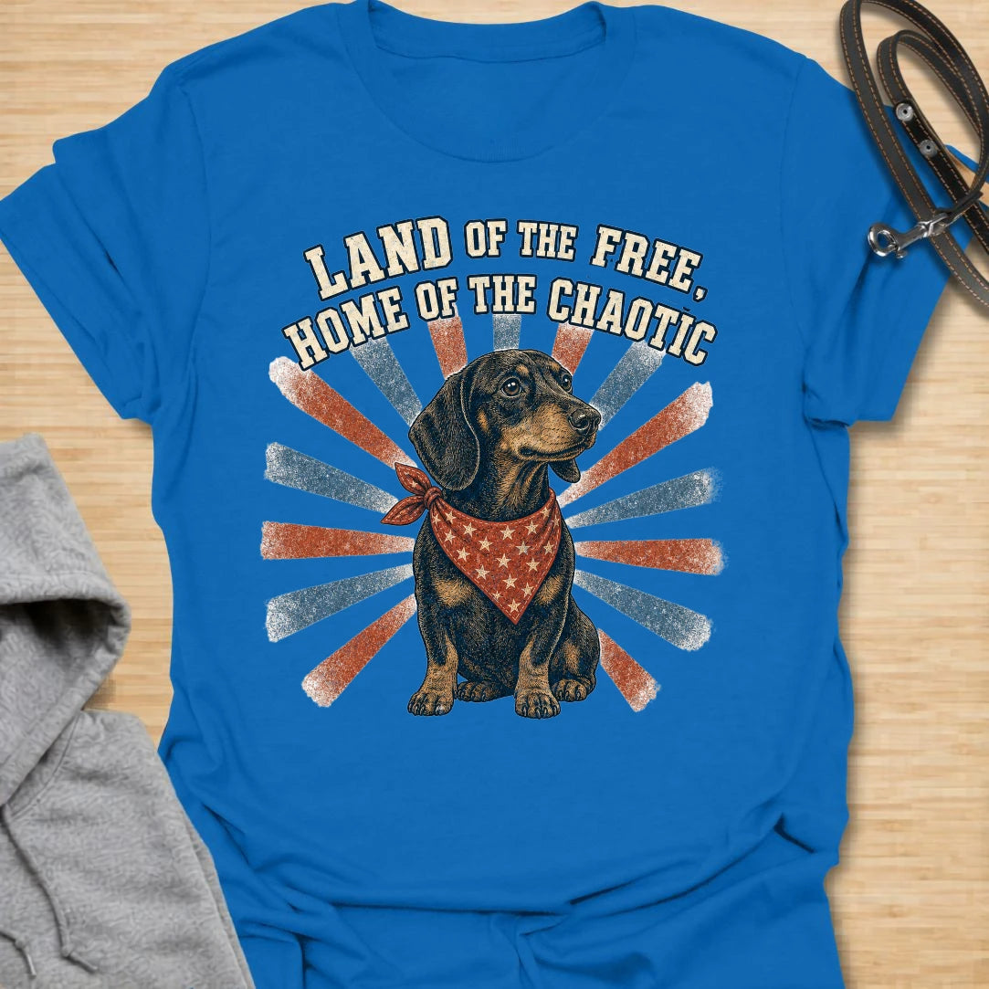 This Land Of The Free Home Of The Chaotic t-shirt is made for dachshund lovers who know their little long dog brings big energy everywhere they go. Featuring a black and tan doxie with a red bandana, vintage patriotic-style rays, and bold distressed text, this funny dog design is great for dachshund moms, dachshund dads, wiener dog fans, rescue dog lovers, and anyone whose home is proudly ruled by dachshund chaos.