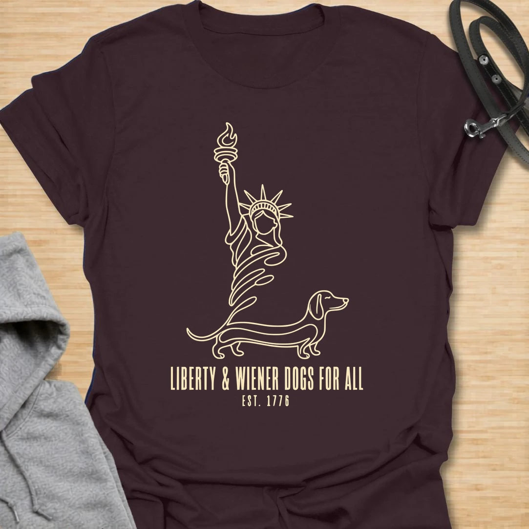 This Liberty And Wiener Dogs For All t-shirt is made for dachshund lovers who want a fun patriotic dog design with a clever wiener dog twist. Featuring a simple line-art Statue of Liberty inspired dachshund design with the phrase Est. 1776, this breed-specific tee is great for dachshund moms, dachshund dads, wiener dog fans, patriotic dog lovers, Fourth of July outfits, and anyone who believes freedom is better with a little long dog.