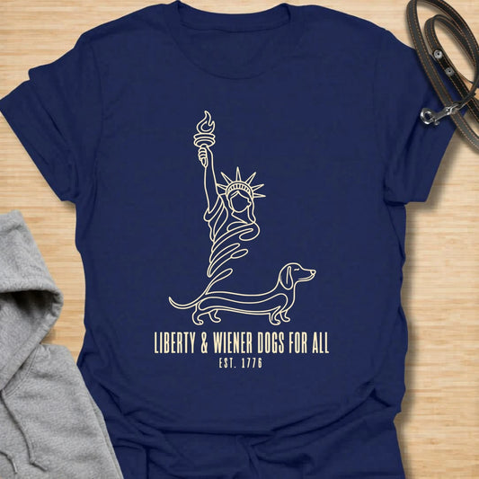 This Liberty And Wiener Dogs For All t-shirt is made for dachshund lovers who want a fun patriotic dog design with a clever wiener dog twist. Featuring a simple line-art Statue of Liberty inspired dachshund design with the phrase Est. 1776, this breed-specific tee is great for dachshund moms, dachshund dads, wiener dog fans, patriotic dog lovers, Fourth of July outfits, and anyone who believes freedom is better with a little long dog.