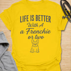 This Life Is Better With A Frenchie Or Two t-shirt is made for French Bulldog lovers who know one Frenchie is wonderful, but two is even better. Featuring a simple Frenchie illustration with clean mixed typography, this design has a sweet, easy-to-wear dog-parent feel for everyday style. Perfect for Frenchie moms, Frenchie dads, French Bulldog owners, rescue dog lovers, and anyone whose life is happier with a little Frenchie chaos.