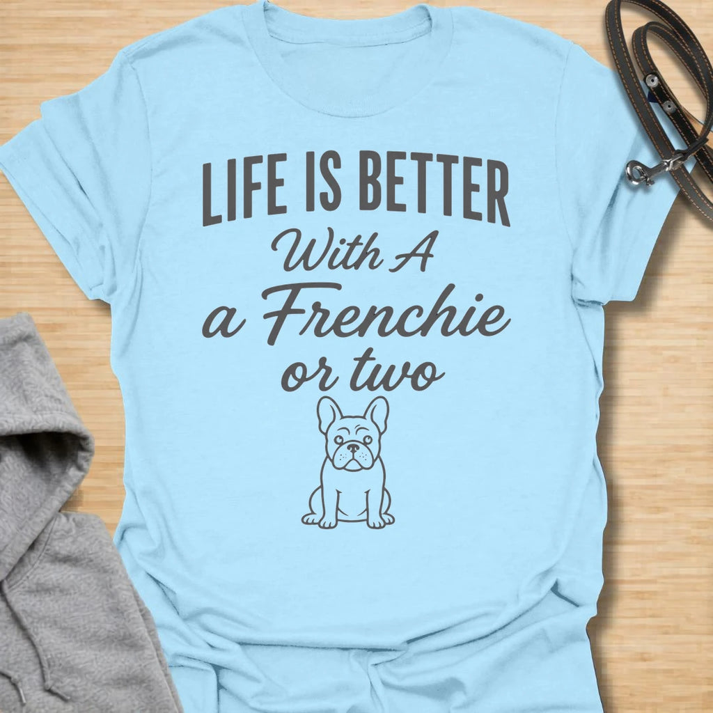 This Life Is Better With A Frenchie Or Two t-shirt is made for French Bulldog lovers who know one Frenchie is wonderful, but two is even better. Featuring a simple Frenchie illustration with clean mixed typography, this design has a sweet, easy-to-wear dog-parent feel for everyday style. Perfect for Frenchie moms, Frenchie dads, French Bulldog owners, rescue dog lovers, and anyone whose life is happier with a little Frenchie chaos.